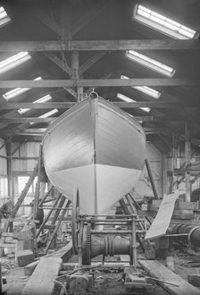 The yawl 'Banzai' in shed at boatyard, 1912. Creator: Kirk & Sons of Cowes.