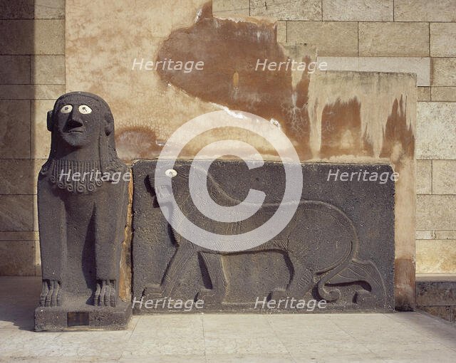 Basalt sphinx and a lion in relief, guarding the Temple of Tell Halaf, c6100 to 5400 BC. Creator: Unknown.