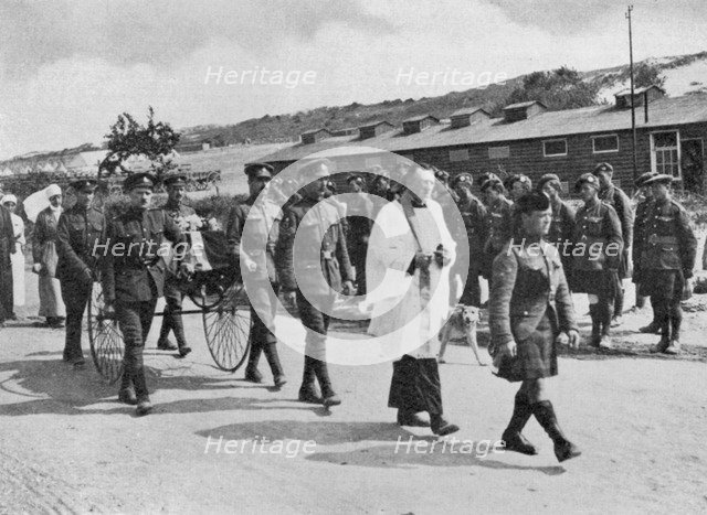 Army chaplain officiating at funeral of nurse killed in air raid on British base near Etables, 1918. Artist: Unknown