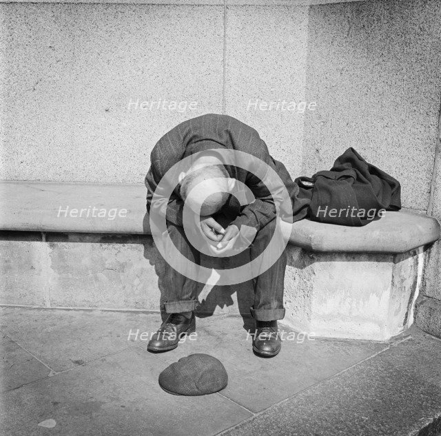 Man seated on a stone bench on Blackfriars Bridge, London, c1946-c1959. Artist: John Gay