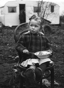 Gipsy girl eating, Lewes, Sussex, 1964. 