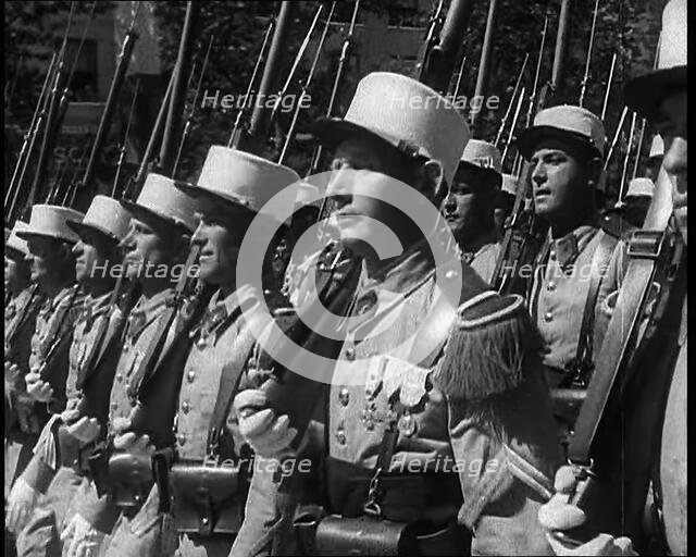 Male French Foreign Legion Soldiers Marching in a Bastille Day Military Parade, 1939. Creator: British Pathe Ltd.