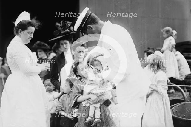 Hospital boat, a mother, her child, and a doctor, upper deck, 1910. Creator: Bain News Service.