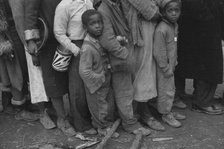 Flood refugees at mealtime, Forrest City, Arkansas, 1937. Creator: Walker Evans.