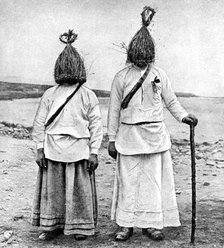 A pair of 'straw boys', Ireland, 1922.Artist: AW Cutler