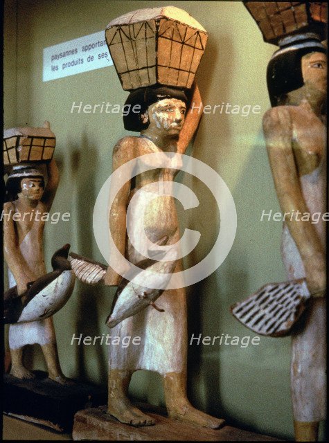 Statue of a peasant woman carrying products of the land to a dead man, made in polychromed wood. …