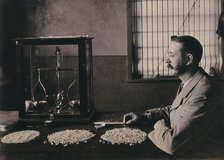 South Africa: an employee of De Beers counting the diamonds mined that day, 1896. Creator: Unknown.