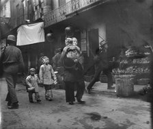 Woman and children walking down a street, Chinatown, San Francisco, between 1896 and 1906. Creator: Arnold Genthe.