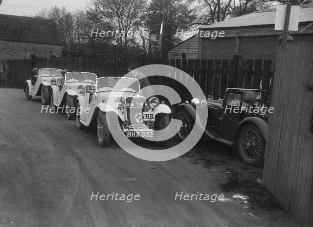 Three Singer cars and a MG PA at a motoring trial, 1930s. Artist: Bill Brunell.