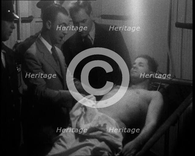 Male American Civilians Examining a Dead Body, 1930. Creator: British Pathe Ltd.