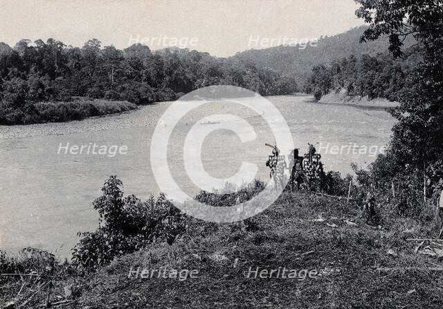 Sarawak: three men standing by the Baram River, c1900. Creator: Unknown.