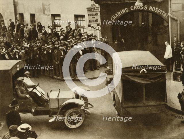 ...Ambulances carrying wounded...into Charing Cross Hospital, London, 1914, (1935).  Creator: S and G.