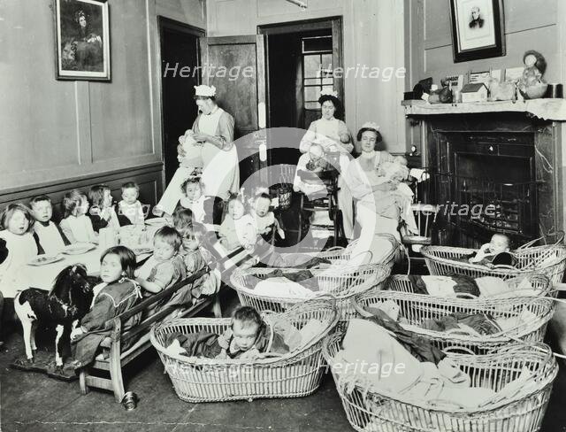 30 Albury Street; Nursey at dinner time, Children in Baskets, 1911. Creator: Unknown.