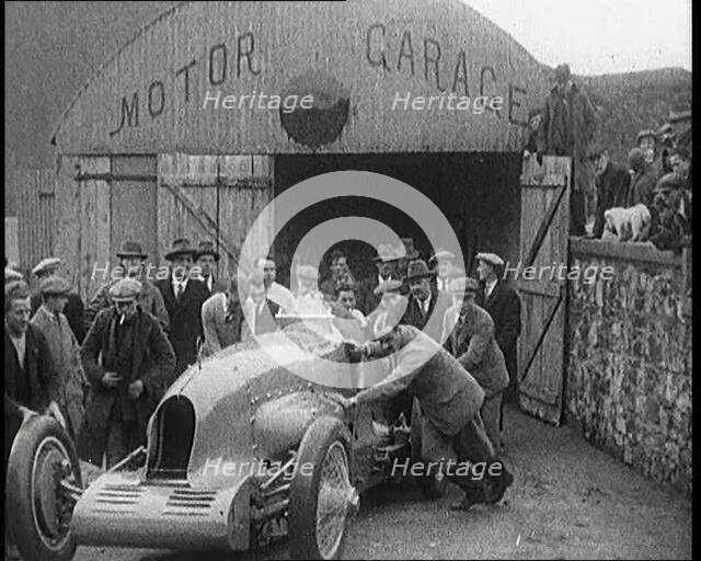 A Crowd of Civilians Watching a Group of Civilians Wheeling Malcolm Campbell's 'Bluebird'..., 1927. Creator: British Pathe Ltd.