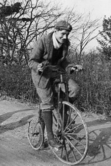 A young Lord Nuffield riding a bicycle down a country lane. Artist: Unknown