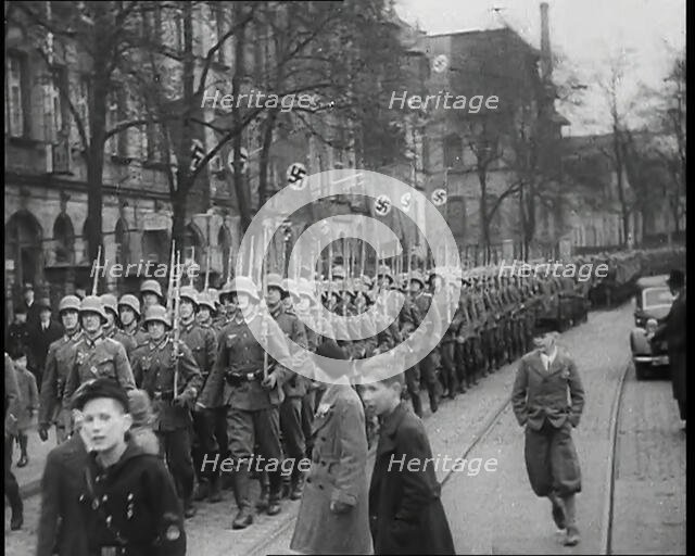German Civilians Watching German Troops Moving Through the Rhineland, 1936. Creator: British Pathe Ltd.