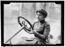 Race car driver Joan Newton Cuneo, seated in racing car, facing left, between 1910 and 1917. Creator: Harris & Ewing.