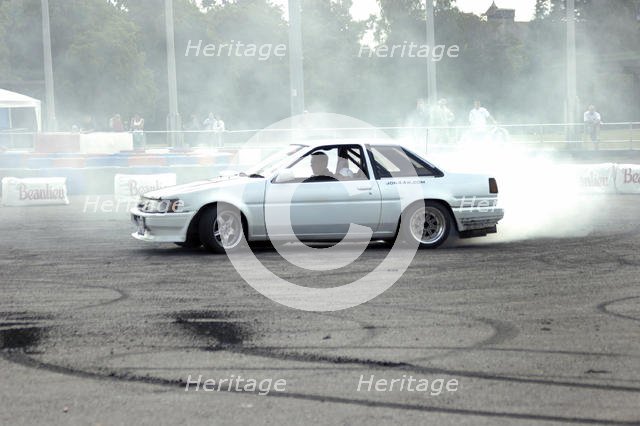Smoking tyres during tyre burn-out. Creator: Unknown.