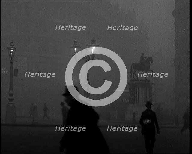 Male Civilians Walking Through the Foggy Streets of London, 1929. Creator: British Pathe Ltd.