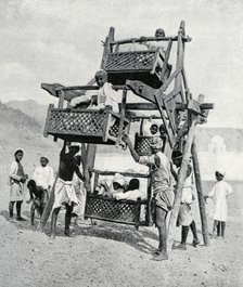 Arabian children enjoying a 'big-wheel', 1922. Artist: Unknown