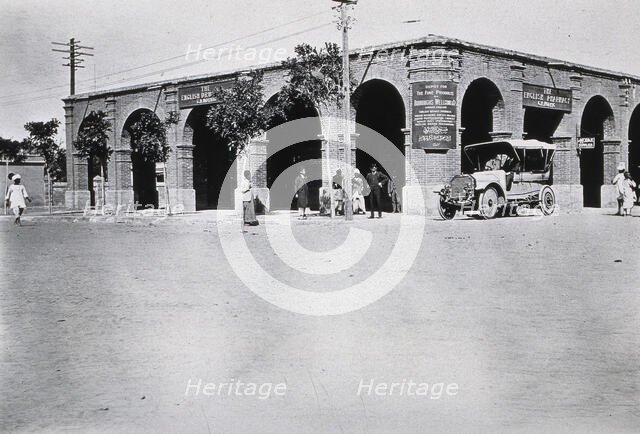 Two men in a car outside the Wellcome pharmaceutical depot in the Middle East, c1910.. Creator: Unknown.