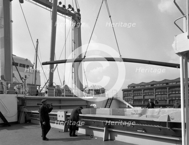 Steel bars being loaded onto the 'Manchester Renown', Manchester, 1964. Artist: Michael Walters