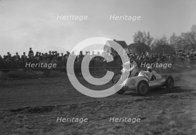 Car racing a motorbike on a dirt track, Arlöv, Scania, Sweden, 1947. Artist: Otto Ohm
