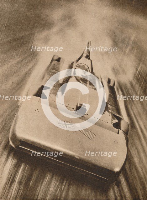 Sir Malcolm Campbell at high speed in `Blue Bird`, 1935. Artist: Unknown.