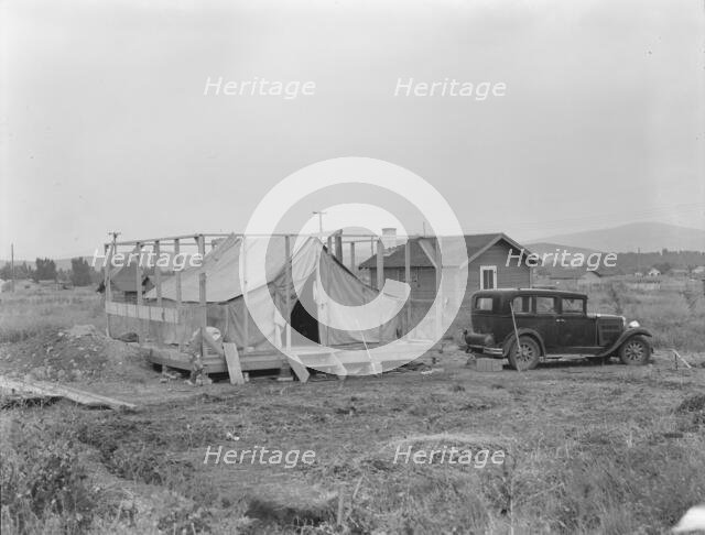 Family living in tent while building the house around them, near Klamath Falls, Oregon, 1939. Creator: Dorothea Lange.