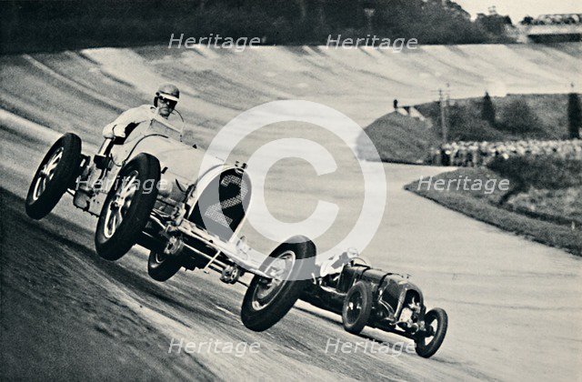 'Earl Howe and Sir Henry Birkin racing at Brooklands', 1937. Artist: Unknown.