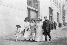Mrs. Mills, Mrs. Hyde, Mrs. Ginnett, a detective and a little girl walking down the street..., 1910. Creator: Bain News Service.