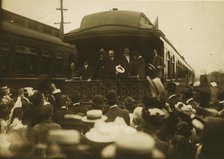 Russian diplomats waving at crowds from the back of a train car, 1905. Creator: Unknown.