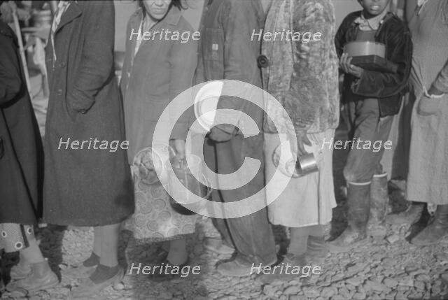 Possibly: Negroes at mealtime in the flood refugee camp, Forrest City, Arkansas, 1937. Creator: Walker Evans.