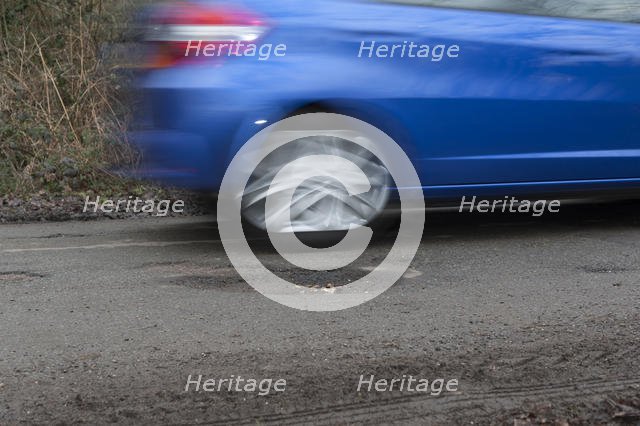 Pot holes in road surface 2017. Creator: Unknown.