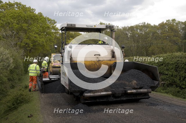 Road resurfacing work repairing potholes Artist: Unknown.