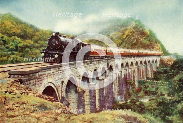 'Between Bombay and Delhi. A striking view of the Frontier Mail passing over a viaduct', 1935 Creator: Unknown.