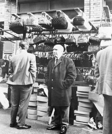 An East End market stall selling handbags, London. Artist: Unknown