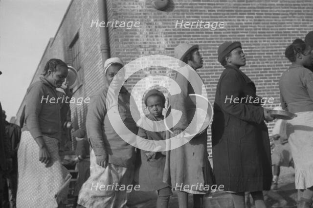 Possibly: Negroes in the lineup for food at the flood refugee camp, Forrest City, Arkansas, 1937. Creator: Walker Evans.