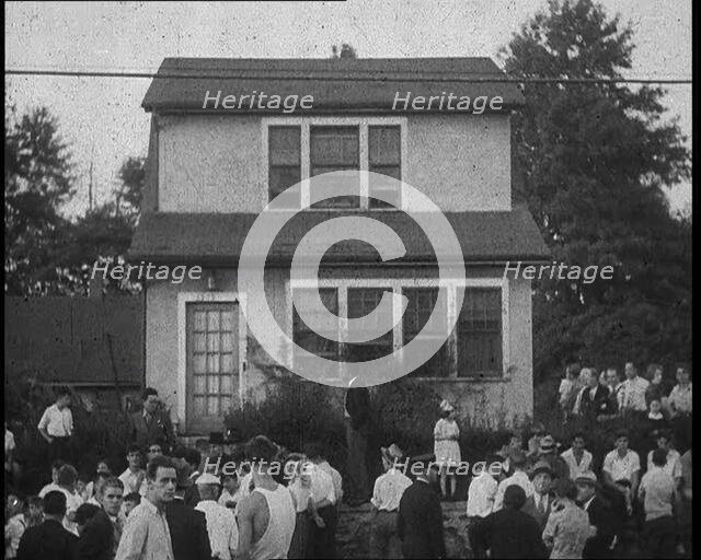 Small Crowd of American Civilians Gathering Outside Bruno Richard Hauptman's House in the..., 1930s. Creator: British Pathe Ltd.