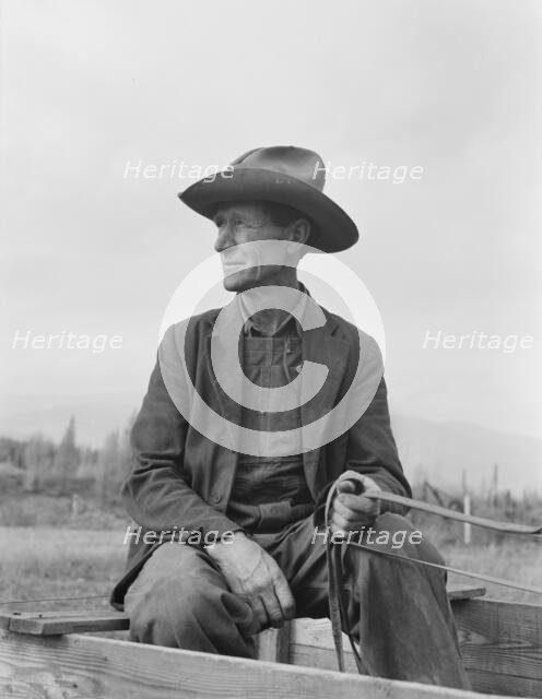 Ex-Nebraska farmer now developing farm out of the stumps, Bonner County, Idaho, 1939. Creator: Dorothea Lange.