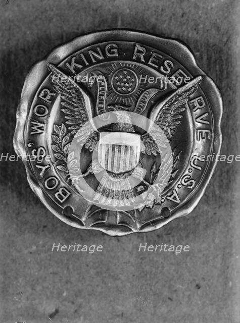 Boys Working Reserve, U.S.A. Badge, 1917. Creator: Harris & Ewing.