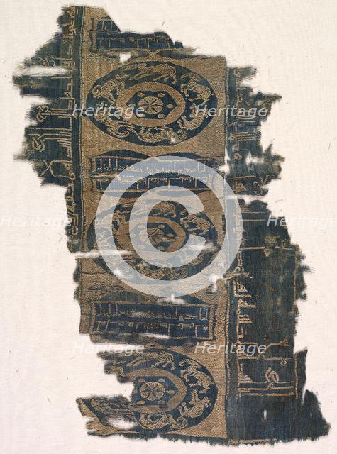 Brocaded silk fragment with running animal roundels and kufic inscriptions, 1530-1950. Creator: Unknown.