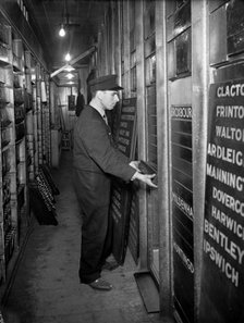 Member of staff changing departure information, Liverpool Street Station, London, 1950. Artist: Unknown