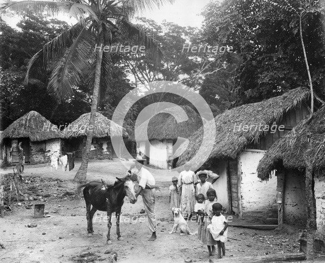 Family outside their home, Coolie Street, Kingston, Jamaica, 1931. Artist: Unknown