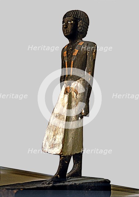 Figurine of a man for a tomb, made of polychromed wood, side view.