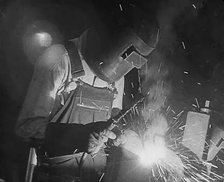 A Factory Worker Using a Blowtorch, 1943. Creator: British Pathe Ltd.