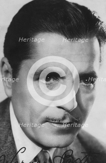 Warner Baxter, (1889-1951), American actor, c1930s-c1940s. Signed photograph. Artist: Unknown