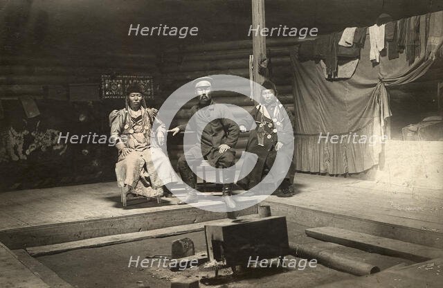 The interior of a Buryat yurt. In the center is a householder with two wives, 1905. Creator: L Veniukov.