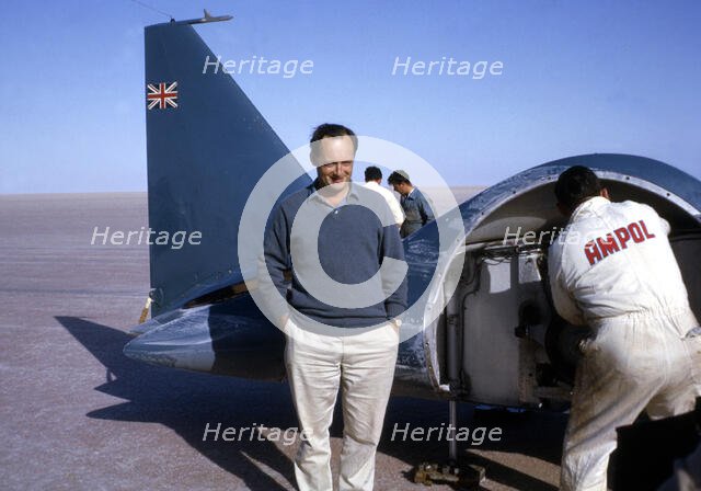 Donald Campbell  in front of Bluebird CN7, Lake Eyre, Australia, 1964. Creator: Unknown.