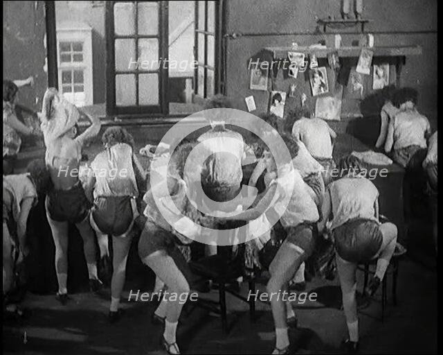 Female Actors Rapidly Changing Costumes For the Next Scene Backstage at the Theatre, 1920s. Creator: British Pathe Ltd.